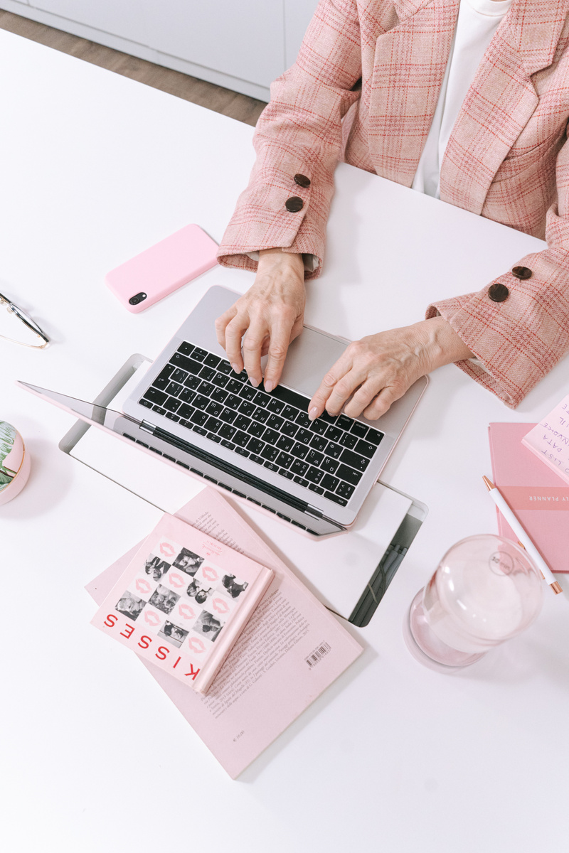 Macbook Pro Beside Pink Bear Plush Toy and Pink Iphone Case