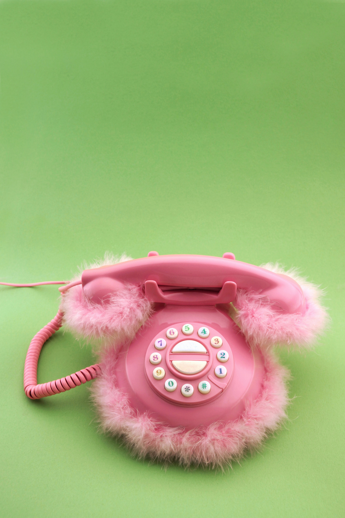 Pink phone on green background